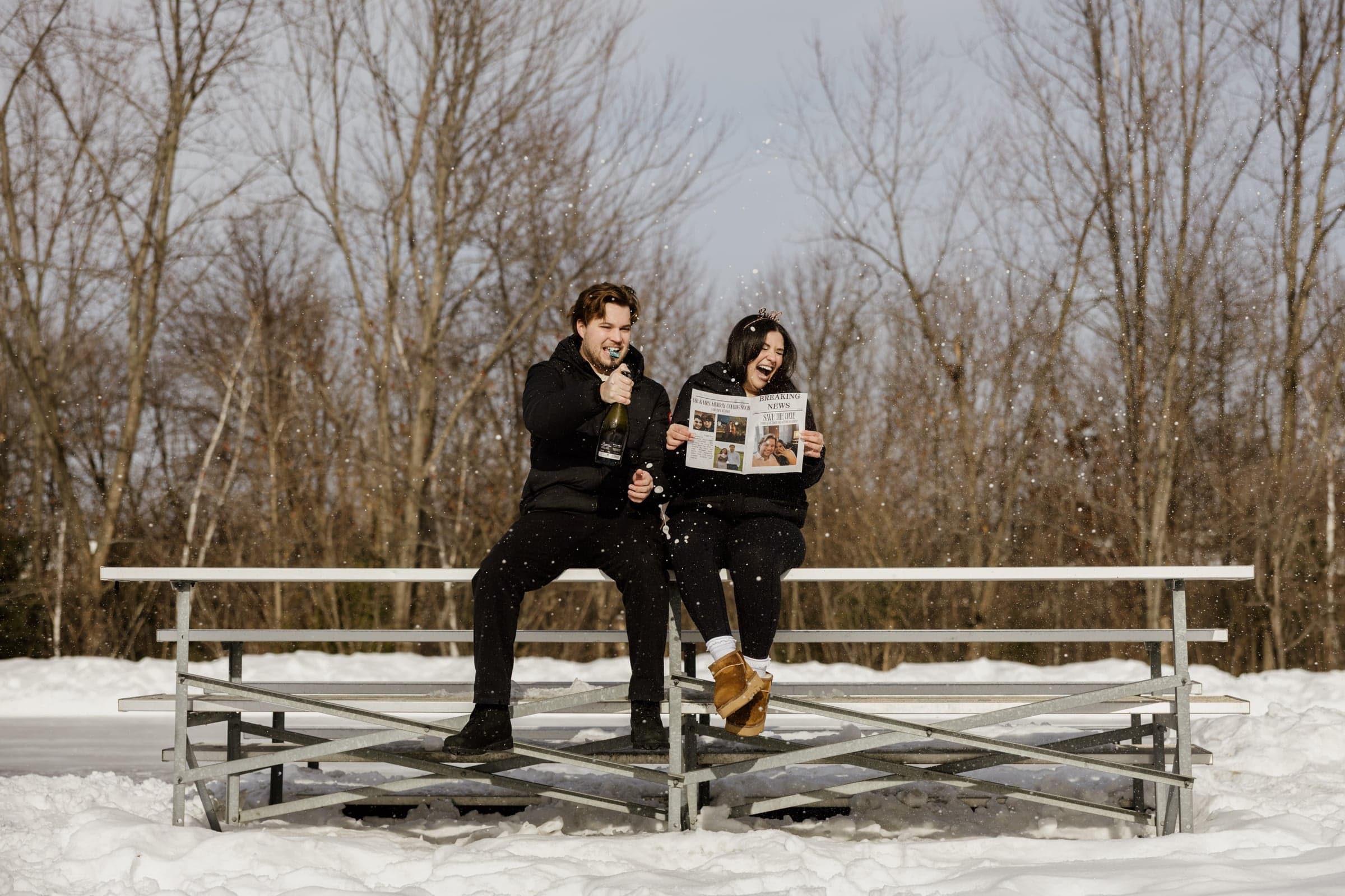 Victoria and Christoph celebrating with champagne in the snow